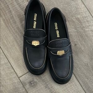 Miu Miu Black Leather Slip-On Loafers with Gold Detail